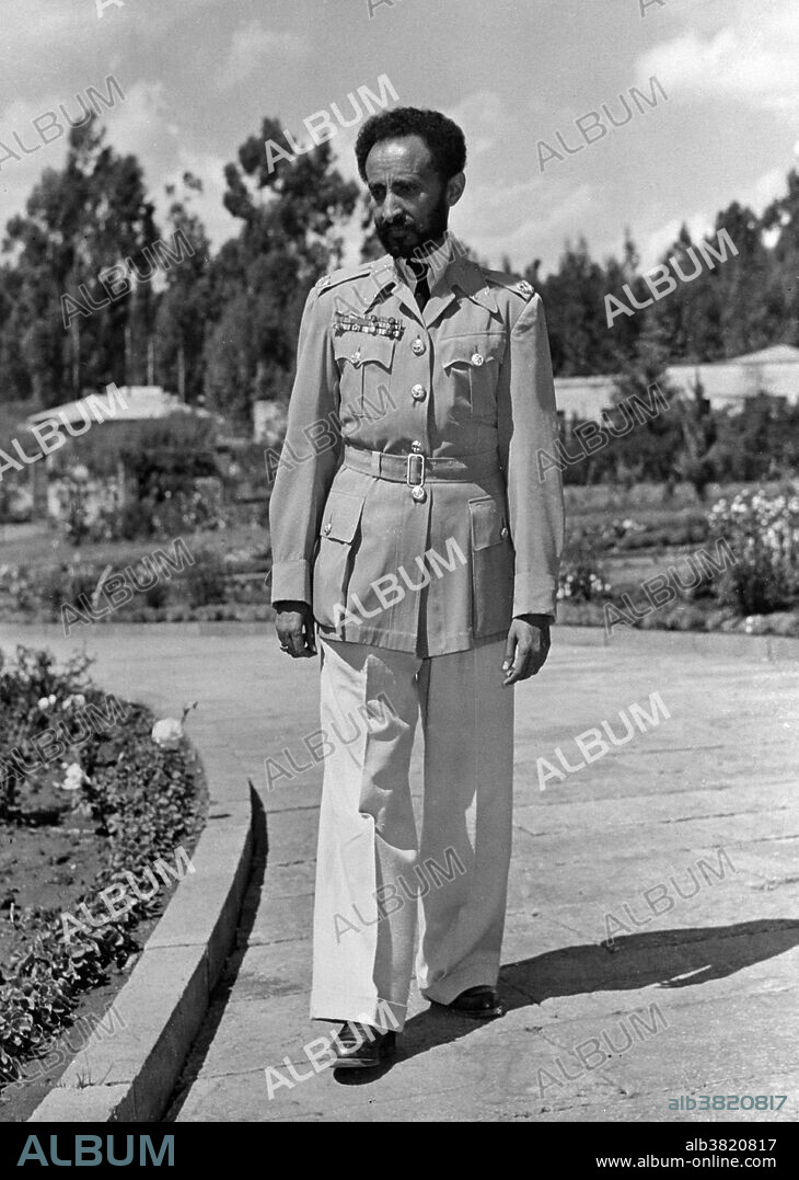 Selassie, emperor of Ethiopia, strolling in the Palace grounds. Haile Selassie I (July 23, 1892 - August 27, 1975) was Ethiopia's regent from 1916-30 and Emperor of Ethiopia from 1930-74. His internationalist views led to Ethiopia's becoming a charter member of the United Nations, and his political thought and experience in promoting multilateralism and collective security have proved seminal and enduring. His suppression of rebellions among the landed aristocracy, which consistently opposed his reforms, and Ethiopia's perceived failure to modernize rapidly enough, earned him criticism among some contemporaries and historians. His regime was also criticized by human rights groups as autocratic and illiberal. Among the Rastafari movement Haile Selassie is revered as the returned messiah of the Bible, God incarnate. He died in 1975 at the age of 83. The state media reported that he had died of "respiratory failure", but imperial loyalists believed that he had been assassinated, and this belief remains widely held to this day. Photographed by the Office of War Information, Overseas Picture Division, circa 1940-46.