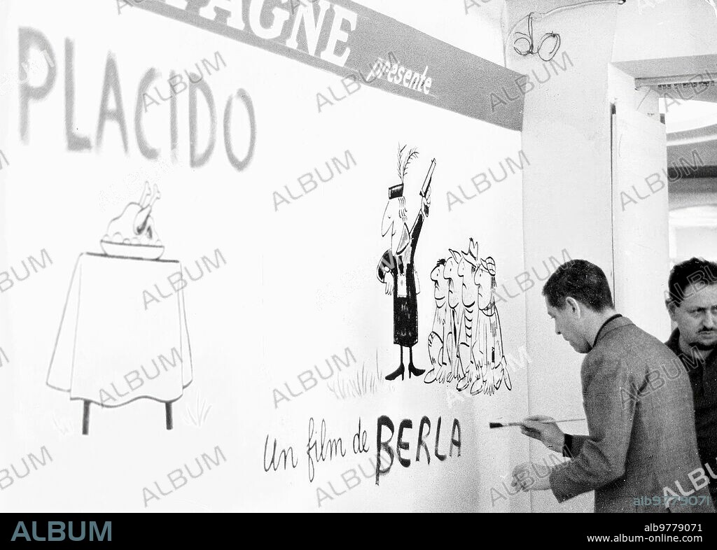 1961. Berlanga pintando el cartel anunciador de su película «Plácido» en el stand de «Uniespaña».