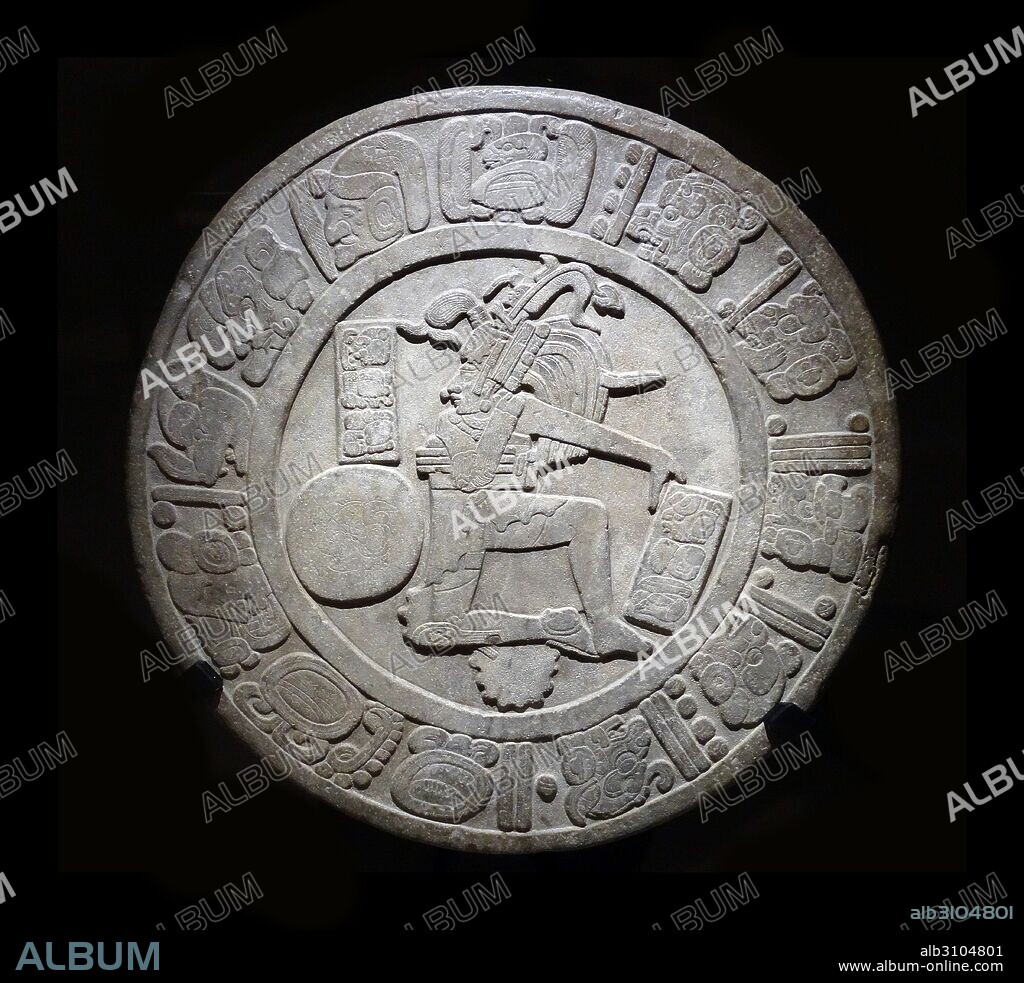 Mayan Chinkultic disc 600-900 AD. This stone disc belongs in the category known as ball court markers, which were set in ball court floors. The motif is a ballplayer in the act of hitting a ball with his hip and the text recounts the date of dedication of the ball court it was set in.