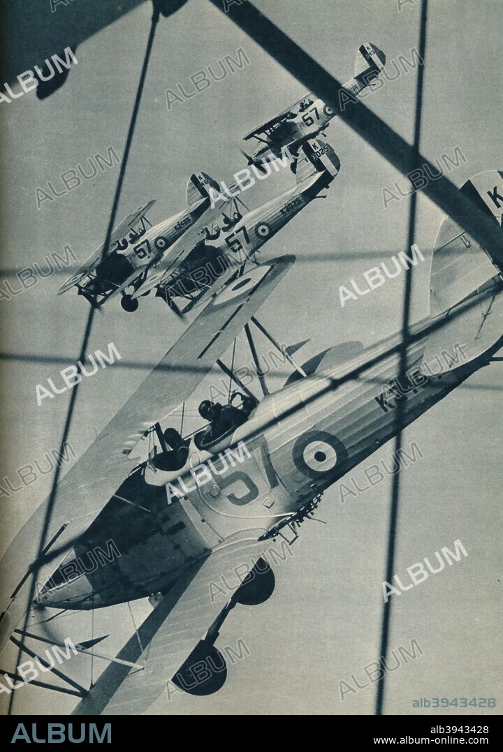 Hawker Hart biplanes flying in formation, c1936 (c1937). The Hawker Hart was a British two seater biplane light bomber aircraft of the Royal Air Force. It was designed during the 1920s by Sydney Camm (1893-1966) and manufactured by Hawker Aircraft. From Wonders of World Aviation, Vol. 1, by Clarence Winchester. [The Amalgamated Press Ltd, London, c1937].