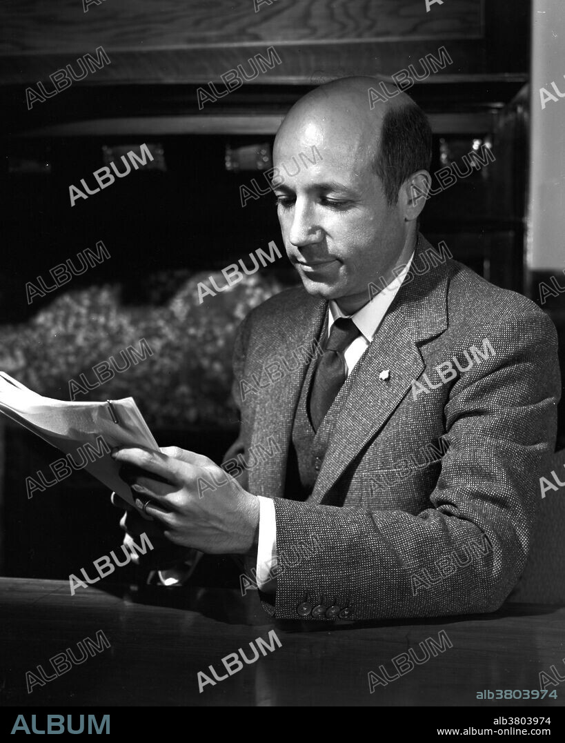 Calvin at his desk taken September 24, 1952. Melvin Ellis Calvin (April 8, 1911 - January 8, 1997) was an American chemist. He joined the faculty at the University of California, Berkeley in 1937 and was promoted to Professor of Chemistry in 1947. Using the carbon-14 isotope as a tracer, Calvin, Andrew Benson and James Bassham mapped the complete route that carbon travels through a plant during photosynthesis, starting from its absorption as atmospheric carbon dioxide to its conversion into carbohydrates and other organic compounds. In doing so, they showed that sunlight acts on the chlorophyll in a plant to fuel the manufacturing of organic compounds, rather than on carbon dioxide as was previously believed. Calvin was the sole recipient of the 1961 Nobel Prize for Chemistry for what is sometimes known as the Calvin-Benson-Bassham Cycle. He was also the founder and Director of the Laboratory of Chemical Biodynamics and simultaneously Associate Director of Berkeley Radiation Laboratory, where he conducted much of his research until his retirement in 1980. He died in 1997 at the age of 85.
