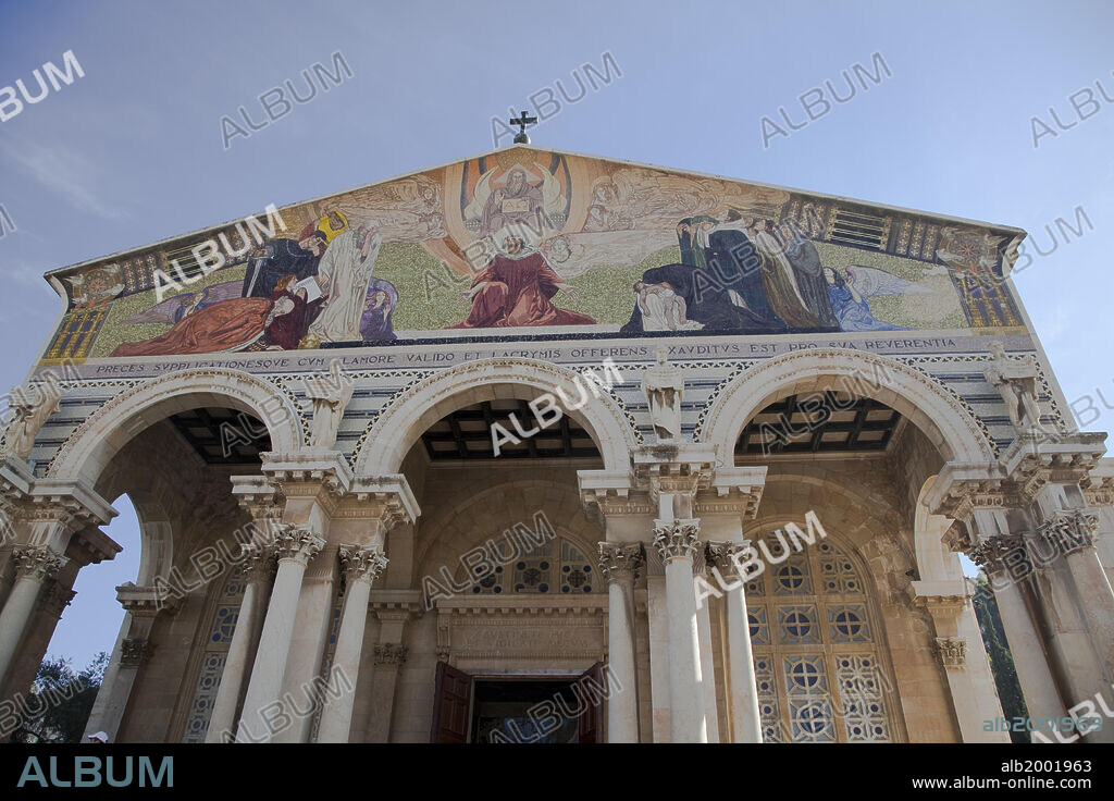 The Church of All Nations, officially named the Basilica of the Agony, is located at the base of the Mount of Olives in Jerusalem. Next to the Garden of Gethsemane that is thought to be where Jesus prayed on the night of his arrest (Matthew 26:36). The Basilica of the Agony was built between 1919 -1924 using funds from 12 different countries. Therefore, it was called the Church of All Nations. The Church has a domed roof, thick pillars, and floor mosaic reminiscent of the Byzantine period. The architect of the building was Antonio Barluzzi. The symbols of the 12 different countries are incorporated into the gold ceilings of 12 cupolas. The 12 cupolas rest on six monolithic pillars. The front of the church features a colorful facade held up by a row of pillars. The mosaic above the entrance depicts Christ as the link between God and humanity.  The Church of All Nations is run by the Franciscans. The Church of All Nations lies on the foundations of two earlier churches: a 12th-century Crusader chapel abandoned in 1345 and a 4th-century Byzantine basilica, destroyed by an earthquake in 746.