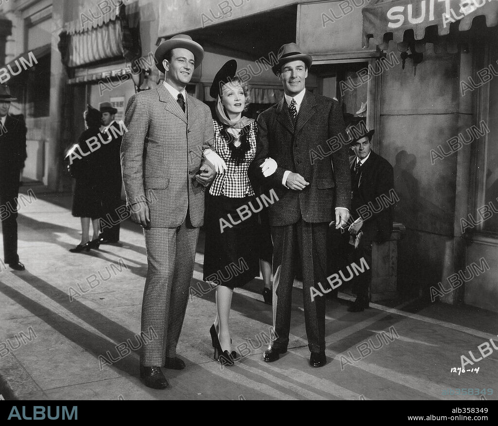 JOHN WAYNE, MARLENE DIETRICH and RANDOLPH SCOTT in PITTSBURGH, 1942, directed by LEWIS SEILER. Copyright UNIVERSAL PICTURES.