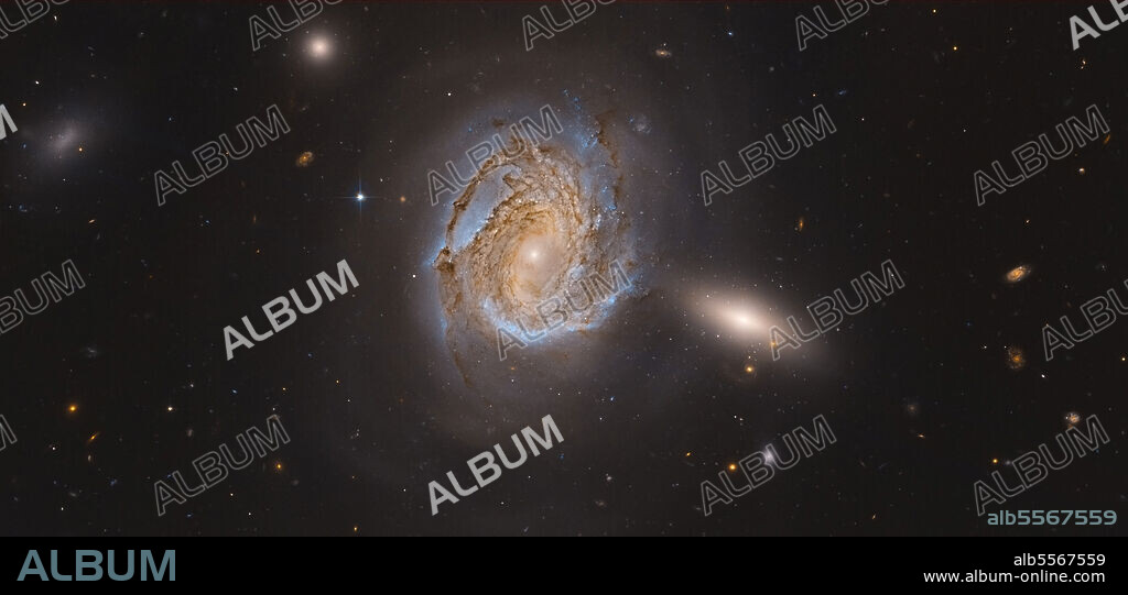 NGC 4911, a spiral galaxy located deep within the Coma Cluster of galaxies in the northern constellation Coma Berenices.