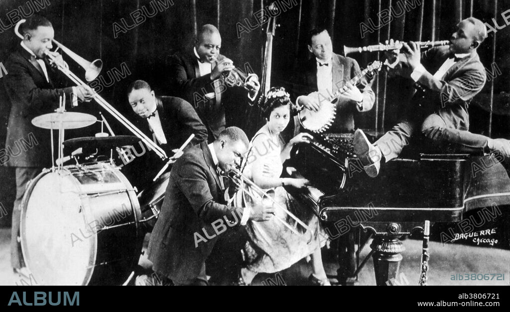Joseph Nathan Oliver, better known as Joe "King" Oliver (December 19, 1881 - April 10, 1938), was an American jazz cornet player and bandleader. In 1922 Oliver and his band went to Chicago, where they began performing as King Oliver and his Creole Jazz Band at the Royal Gardens cabaret. In addition to Oliver on cornet, the personnel included his Louis Armstrong on second cornet, Baby Dodds on drums, Johnny Dodds on clarinet, Lil Hardin (later Armstrong's wife), on piano, HonorÃ© Dutrey on trombone, and William Manuel Johnson on banjo and bass. Recordings made by this group in 1923 for Gennett, Okeh, Paramount and Columbia Records demonstrated the serious artistry of the New Orleans style of collective improvisation or Dixieland, and brought it to the attention of a much wider audience.
