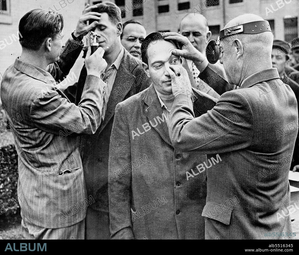 Nathan Leopold (center) has eyes examined by Dr. C.L. Garris at Illinois state penitentiary Inmates arranged October 30, 1946. to donate their eyes to an eye bank.The eyes of a murderer are examined in 1946. Leopold offered them. After death, for transfer to a blind person. January 17, 1952. (Photo by Associated Press Newsphoto).