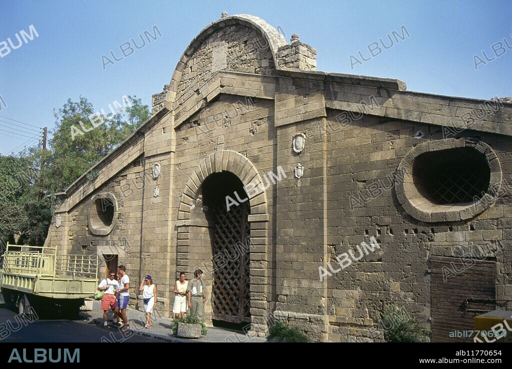 "People in the sunshine outside the arched entrance to the Famagusta Gate, constructed in 1567 and designed as the largest and most elegant in Nicosia, now serving as a cultural centre in the city" *** Local Caption ***.