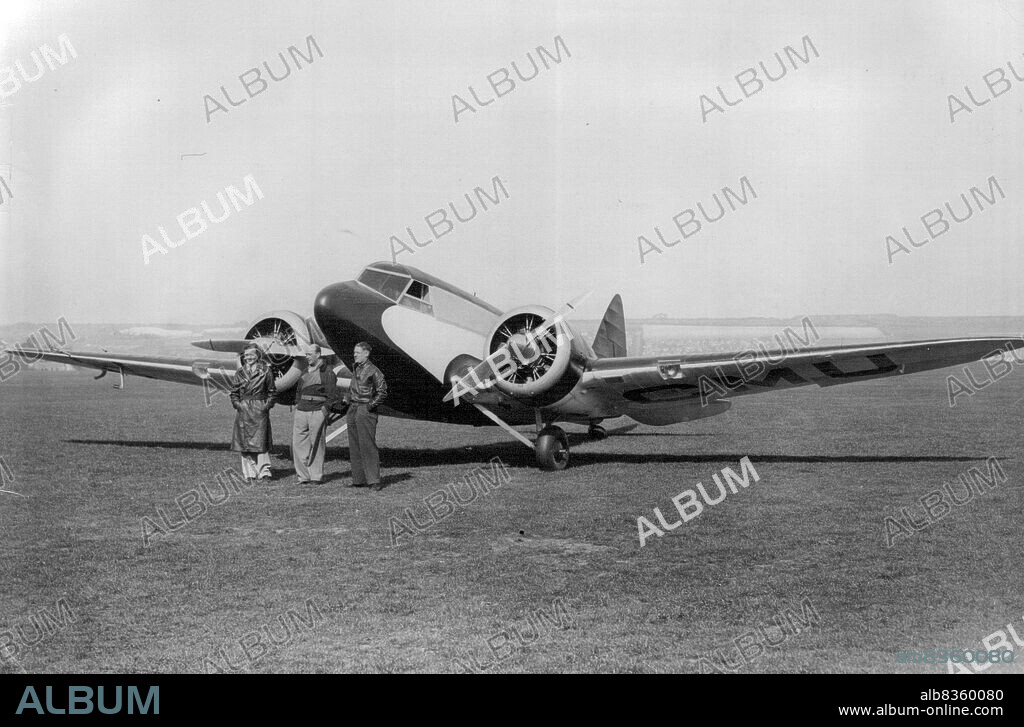 Capt. T. Neville Stack, the famous airman, inspects his new racing aeroplane, which he will pilot in the London to Melbourne air race with Mr. Turner. The machine is an Airspeed Viceroy and was on view at Portsmouth Air Port, for the first time today Sept. 28th.Capt. T. Nivelle Stack (centre) with Mr. Sydney L. Turner and Mr. J.H. Gordon MacArthur, ***** and Wireless Operator, in front of the machine. November 5, 1934. (Photo by Sport & General Press Agency, Limited).
