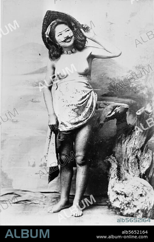 Ethnology / Japan. Ainu (descendants of early Caucasoid people in Hokkadio). Young Ainu woman with moustache tattoo. Studio shot, c. 1905.