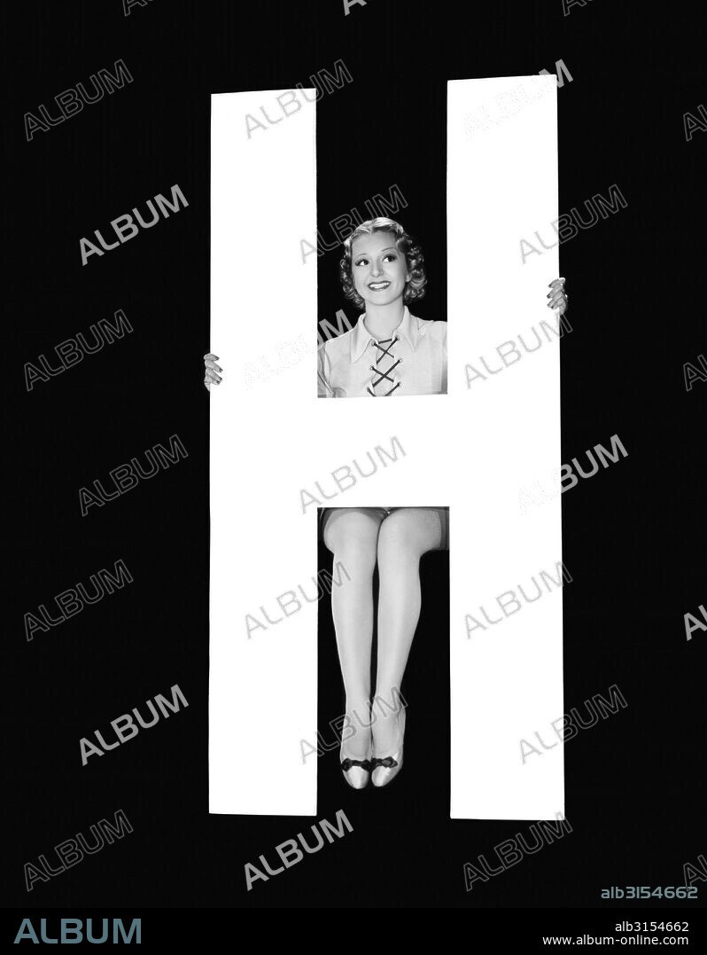 Hollywood, California:  c. 1935. The letter 'H' accompanied by an attractive young woman.