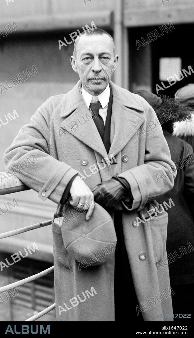 Sergei Vasilievich Rachmaninoff  (1873-1943) Russian composer, pianist and conductor. After 1917 Revolution he left Russia and settled in America in 1918. Three-quarter image in overcoat, hat in hand, looking at camera. Music.