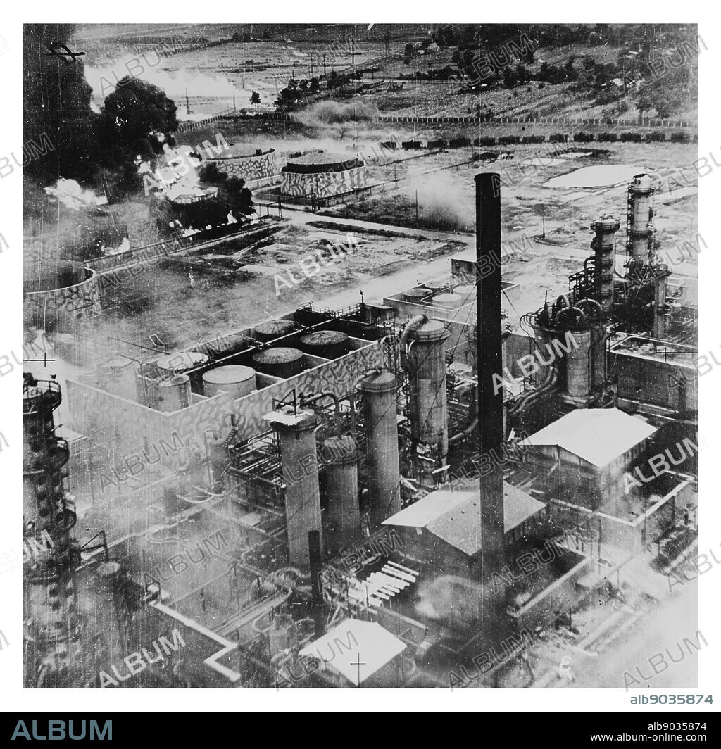 Photograph of Oil storage tanks at the Columbia Aquila Refinery burning after the air raid of B-24 Liberator bombers of the United States Army Air Force. Dated 1943.
