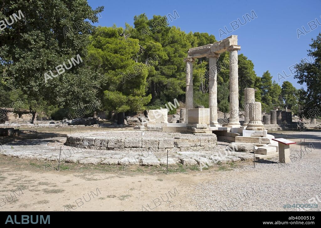 The Philippeion at Olympia, Greece. The Philippeion in the Altis of Olympia was an Ionic circular memorial of ivory and gold, which contained statues of Philip II of Macedon's family, Alexander the Great, Olympias, Amyntas III and Eurydice I. It was made by the Athenian sculptor Leochares in celebration of Philip's victory at the battle of Chaeronea (338 BC). Olympia, a sanctuary of ancient Greece, is probably best known for having been the site of the Olympic Games in classical times.