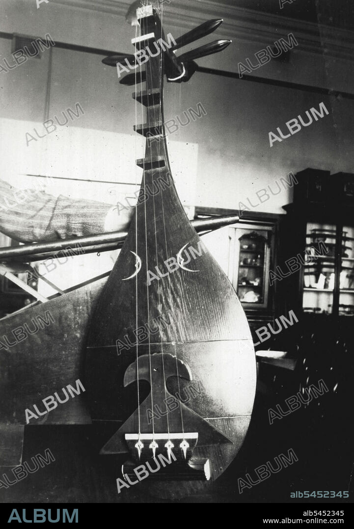 A Japanese lute of the present day, It is caused from solid wood, and is used as a bass. November 27, 1933.