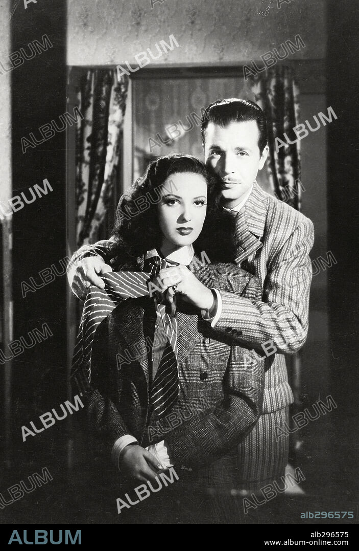 DICK POWELL and LINDA DARNELL in IT HAPPENED TOMORROW, 1944, directed by RENE CLAIR. Copyright UNITED ARITSTS.