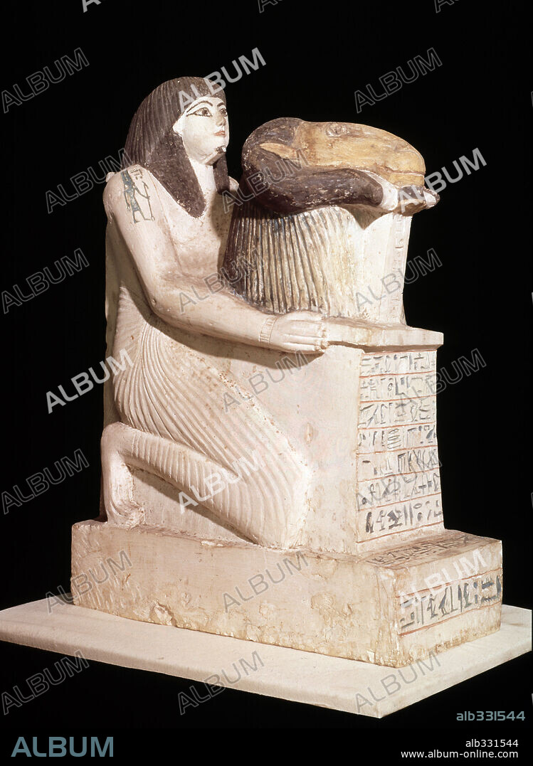 Priest holding image of God Amun or Amon, Egyptian limestone sculpture.
