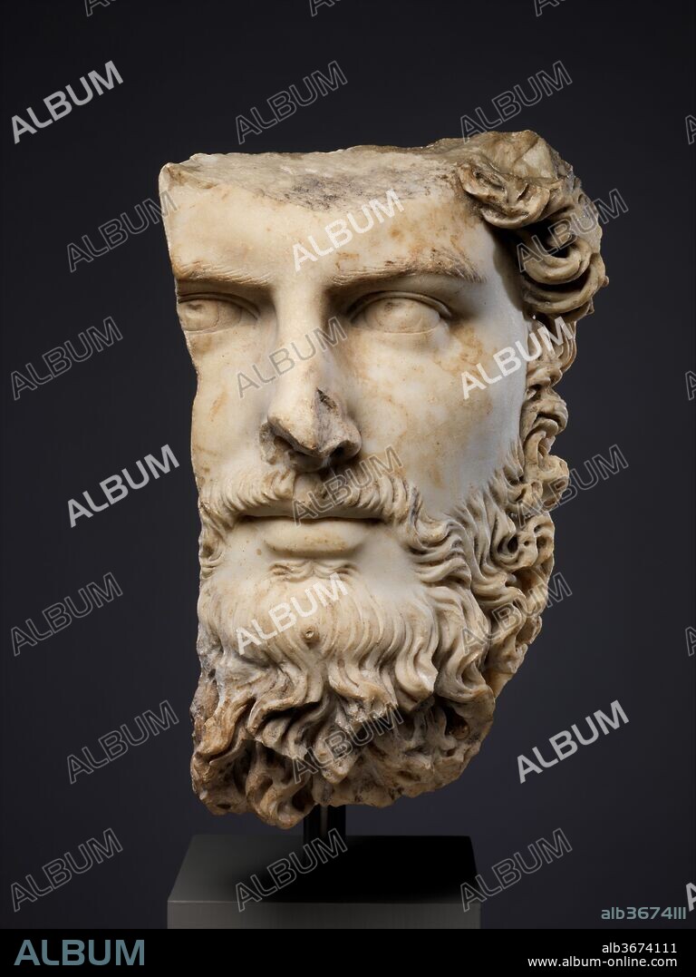 Marble portrait of the co-emperor Lucius Verus. Culture: Roman. Dimensions: H. 14 1/2 in. (36.8 cm). Date: A.D. 161-169.
This fragmentary head comes from an over-life-sized portrait bust or statue of Lucius Verus, co-emperor with Marcus Aurelius (r. A.D. 161-180). At the beginning of his reign, Verus was sent to the East to direct military operations against the Parthians, and although the war was concluded successfully in A.D. 166, his returning troops brought back the plague, which ravaged the Empire for several years thereafter. He is compared unfavorably with Marcus Aurelius by the ancient sources, but the portrait shown here has a leonine majesty that gives little indication of his reputation as an idle and dissolute ruler. It is typical of Antonine style in its use of luxuriant drillwork in the hair and engraved eyes to dramatize the basically naturalistic image.
