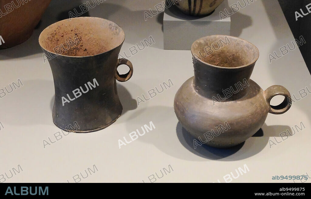 Cup-shape Vessel, c. late 4000-early 3000 BCE, 4-3/8 x 4-11/16 x 4 in. (11.1 x 11.9 x 10.2 cm), Earthenware, China, 40th-30th century BCE, These evenly potted, grey earthenware handled cups appear to have been shaped partly on the wheel. The thin, burnished walls and round strap handles are clearly articulated. The vessels most likely came from Shandong or Henan provinces in north China.