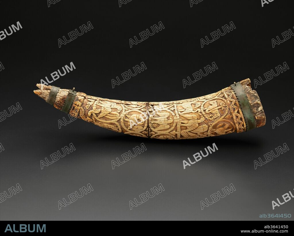 Oliphant. Culture: South Italian. Dimensions: Overall: 16 15/16 x 3 9/16 in. (43 x 9 cm). Date: 12th century.
Decorated elephant tusks could be employed as drinking vessels, as horns to announce the hunt, or as symbols of feudal rights. In churches, some served as reliquary containers. As this example shows Christ as the Lamb of God, it probably was made for a Christian patron.