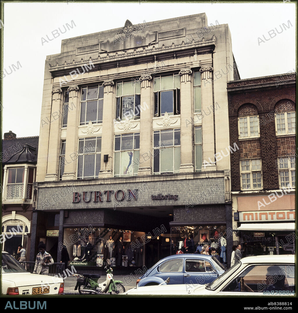 NICHOLAS ANTHONY JOHN PHILPOT. Burton,  1-3 High Road, Wood Green, Haringey, Greater London Authority, 1976-1989. The Burton store at 1-3 High Road, with tall pilasters crowned by Ionic capitals. Foundation stones were laid by members of the Burton family during construction 1931. In the early 21st century, the premises was occupied by Curry's and later by a Tesco Express store.