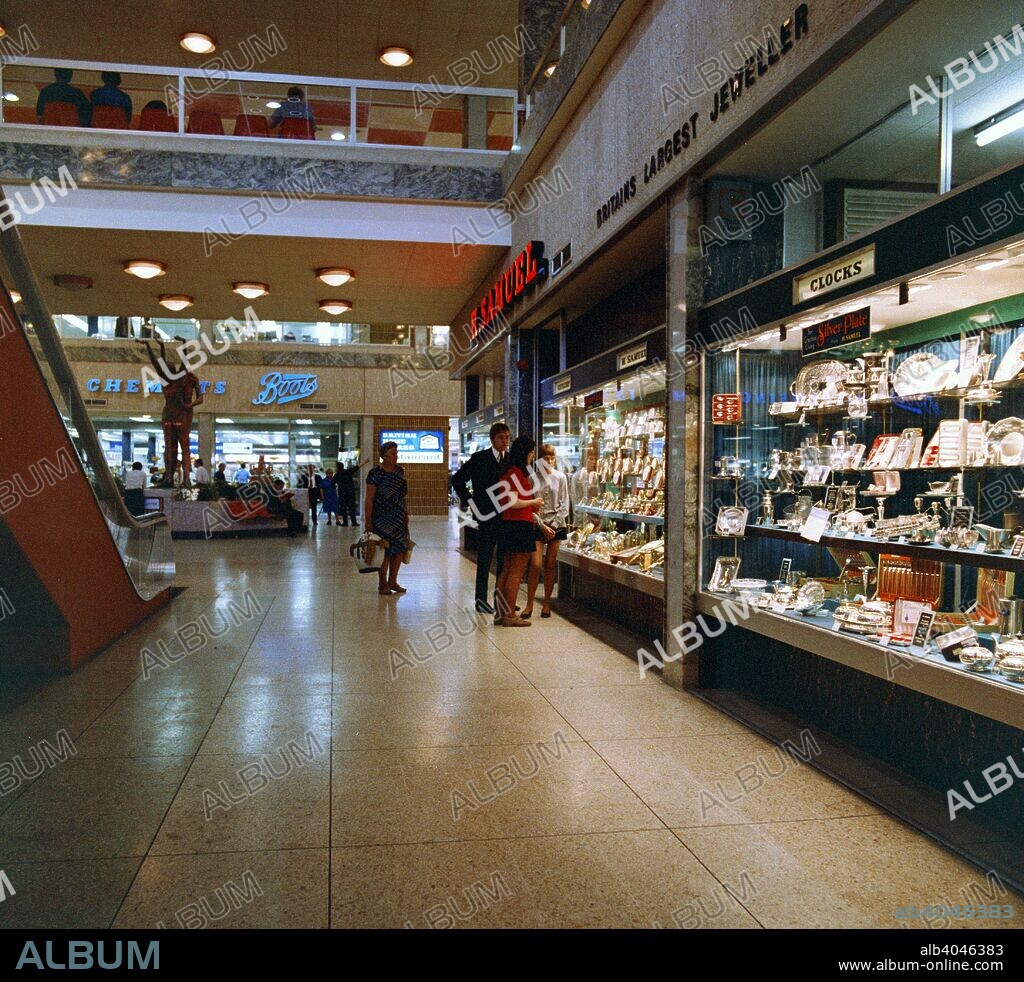 H Samuel's jewellers in the new Arndale Centre, Doncaster, South Yorkshire, 1969. The new Arndale Shopping Centre in Doncaster opened in 1969. The new generation of shopping centres was set to revolutionise shopping in the same way that the development of the supermarket did in the post war years. This new development in Doncaster has undergone a few refurbishments over the years and the controversial statue of the abstract naked couple was rumoured to have found a home in later years in the garden of one of Doncaster's suburban houses, but H Samuel, Boots and British Home Stores still occupied the same shop units some forty years after the photograph was taken.