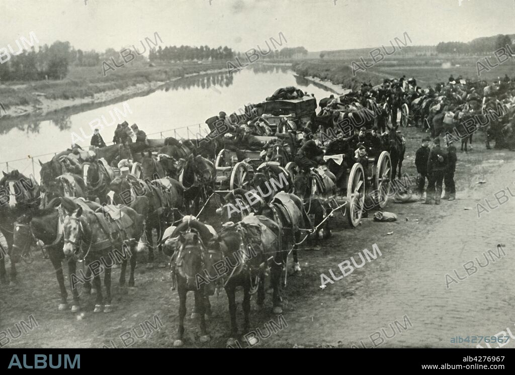 'The Battle of the Rivers', (1919). Scene from the First World War, 1914-1919: 'A detachment of the Belgian Artillery preparing to take up a position of attack on Alost [Aalst, in Flanders, Belgium], after having been driven out by the Germans. In this they were successful, but their success was short-lived, the ever-increasing horde of Germans compelling them to retire upon Antwerp.' From "The History of the Great European War: its causes and effects", Vol. II, by W. Stanley Macbean Knight. [Caxton Pulishing Company, Limited, London, 1919].