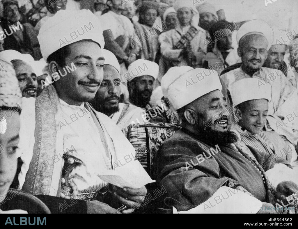 Imam Ahmed Bin Yaha Muhammad Hamid, king of tiny Yemen in the south west corner of the Arabian Peninsula is seen here, watching a military parade in Taiz Feb. 10th. The Parade was held to celebrating his military success in 1948 over Seiyed Abdullah Ibn Al Wazir, who led a coup in which the former king was Assassinated. Others in this group are: Princess Seif El Islam Abdel Rahaman, Youngest of the sons of the Assasssinated King; crown prince Seief El Islam Mohammed in the family. March 3, 1950. (Photo by Associated Press Photo).