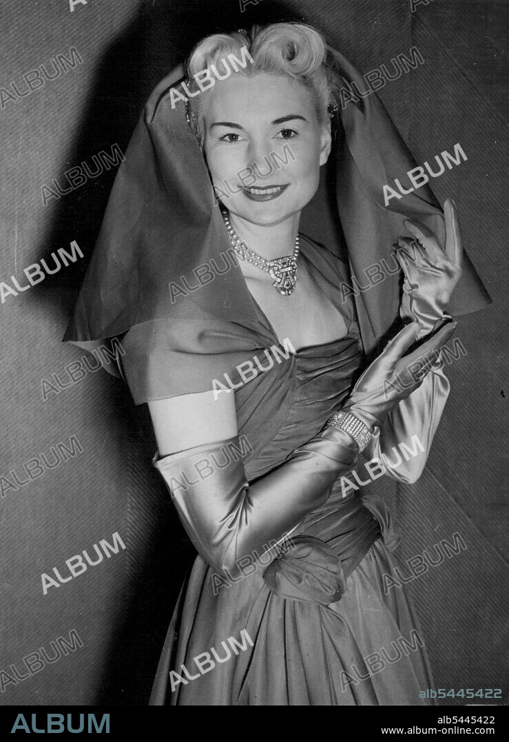This Organza coif, for wear with an afternoon or evening dress, falls from the crown of the head to the shoulders and does not cover the face. January 11, 1953. (Photo by Planet News Ltd.).