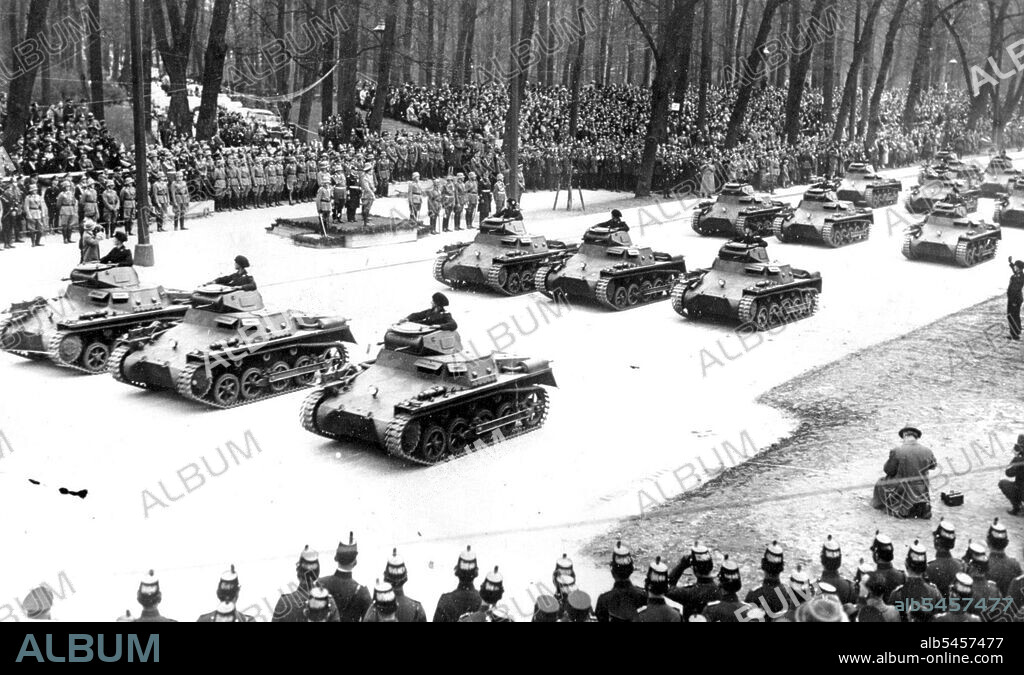 Hitler celebrates birthday with big ***** -- Some four hundred tanks which ***** by ***** he took his salute in the Lustgarten to-day.
***** 47th birthday was made a National holiday in Germany today, and was celebrated in Berlin with he great Tarade when 14,000 troops marched past Hitler, 400 Tanks and  Dozens of lorries, with powerful anti-aircraft guns and ***** lights took part in the big parade. Hitler accompanied by the ***** War Minster house in the Wilhelmatrasse, in an open car, and ***** loudly cheered by tremendous crowds, as he drove to the tiargarten, where he took the salute at the big march past. May 25, 1936.