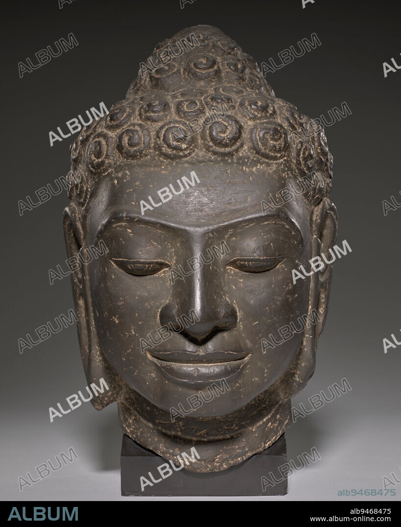 Buddha Head, 8th century, 10 1/2 x 8 in. (26.67 x 20.32 cm), Limestone, Cambodia or Thailand, Mon-Dvaravati Style, This Buddha demonstrates a critical innovation of Southeast Asian sculpture: the early translation of established Indian prototypes into distinctly local expressions. The sculptor fully captures the calm bliss of the enlightened being while subtly incorporating the facial features of the indigenous population. Similarly, artists of the Mon-Dvaravati period exaggerated the Buddhas snail-shell curls, an attribute codified in Indian aesthetic treatises; the tight whorls would have had special significance to a culture where shells were valued forms of ornamentation.