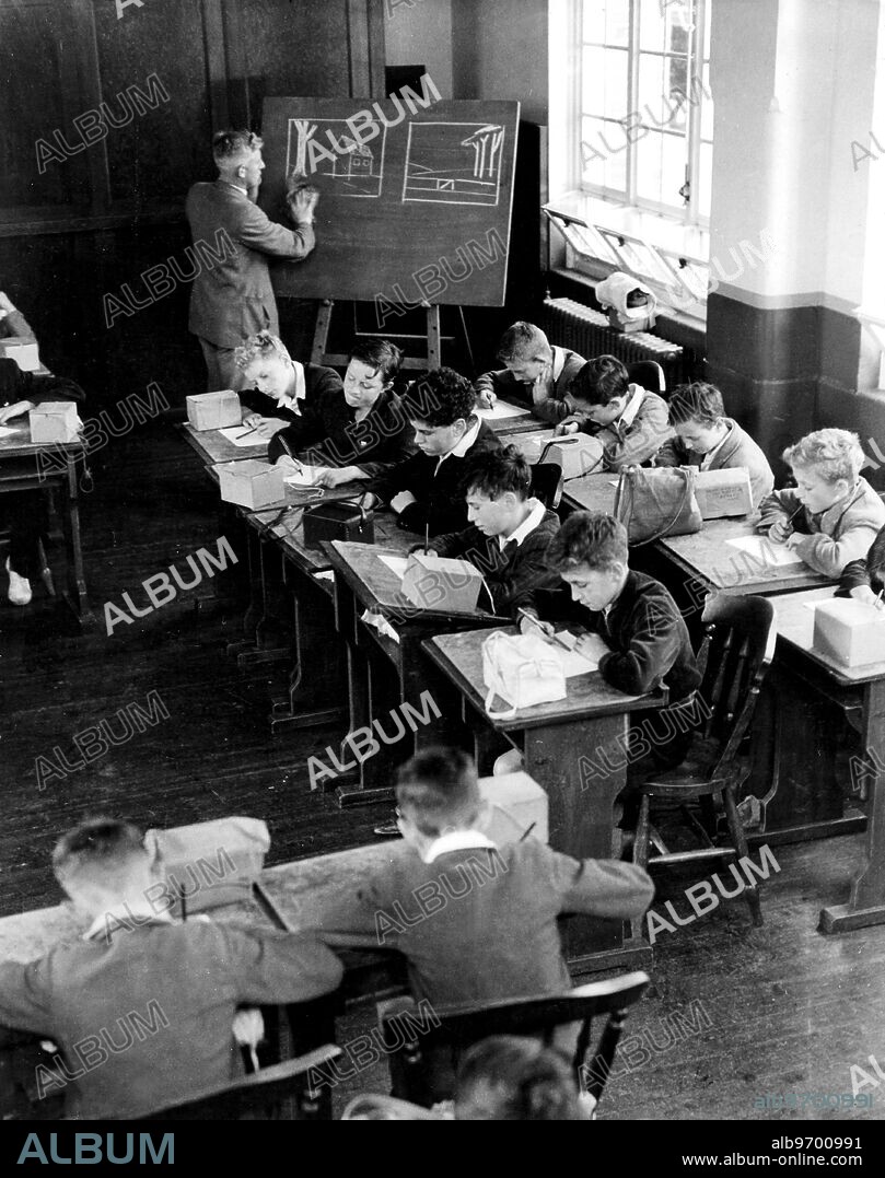 Children at school in war time - lessons - drawing - with gas masks in 1939.