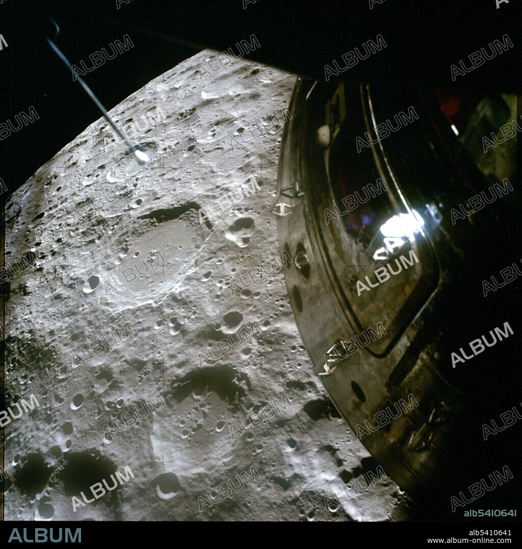 Apollo 13 view of the Moon. This photograph of Chaplygin crater (center left) was taken through one of the Lunar Module windows using a camera intended for surface photography (note the plus-shaped Réseau markings). Blurry, dark, vertical stripes are out-of-focus scale marks on the LM window, used to judge angles and distances. The hatch on the Command Module is prominent in the foreground.