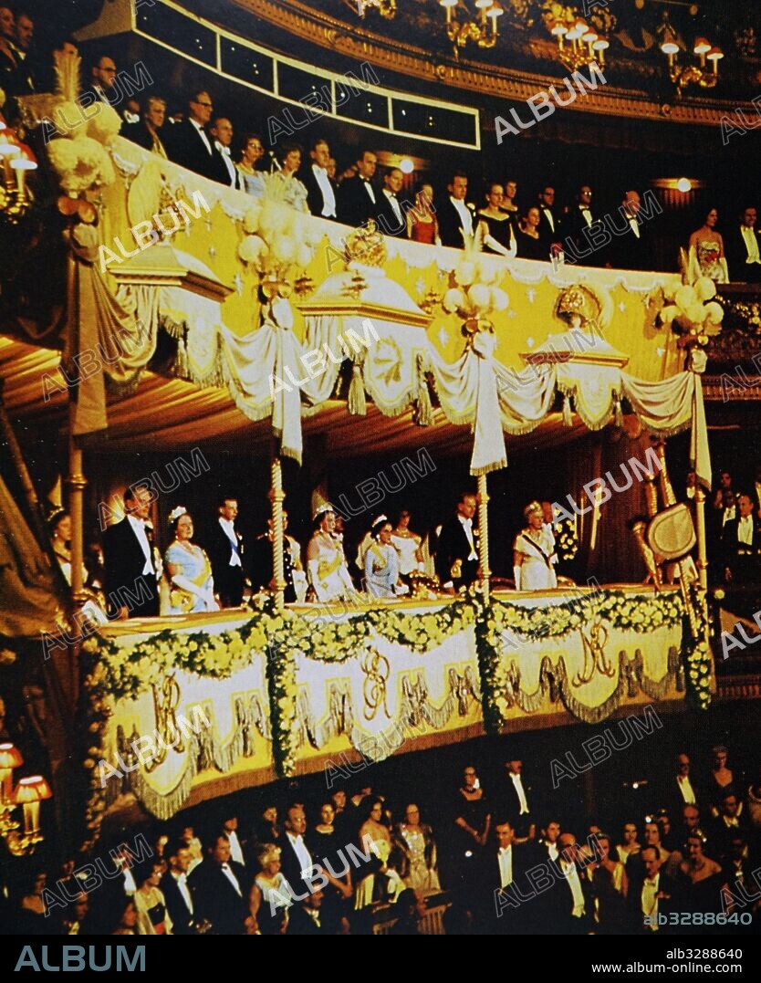 Photograph of Queen Elizabeth II with her guests, the King Birendra Bir Bikram Shah and Queen Aishwarya Rajya Laxmi Devi Shah of Nepal, in the Royal Box. Dated 20th Century.