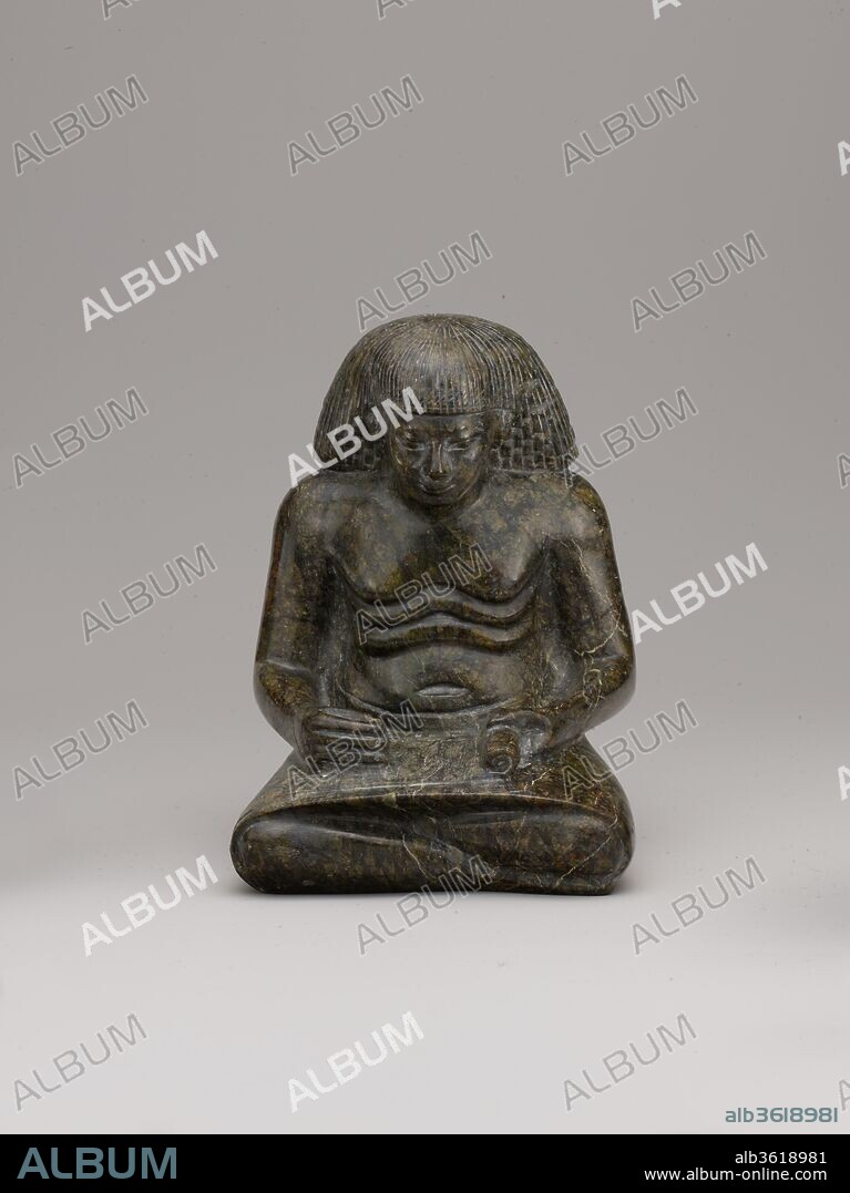 Statuette of a Scribe. Dimensions: H. 12.5 cm (4 15/16 in). Dynasty: Dynasty 18. Reign: reign of Amenhotep II-Amenhotep III. Date: ca. 1391-1353 B.C..
This statuette depicts a seated scribe with a scroll of papyrus across his lap. His kilt is drawn tightly around his knees to create a flat surface on which to write. He would have held a reed brush in his right hand and would have unrolled the papyrus with his left hand. The deep wrinkles across his chest indicate that he is no longer a young man.