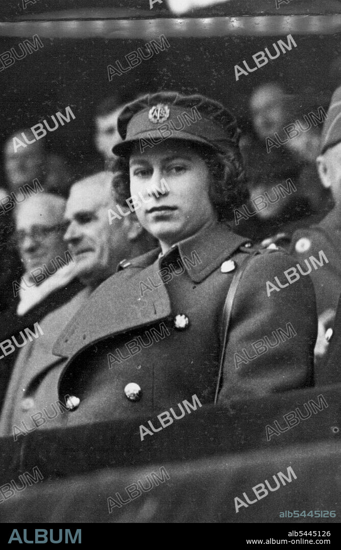 ***** And Queen At Cup Final. H.R.H. Princess Elizabeth in A.T.S. uniform. The King and Queen accompanied by Princess Elizabeth attended the Chelsea V Millwall South Cup Final at Wembley. June 4, 1945. (Photo by L.N.A.).