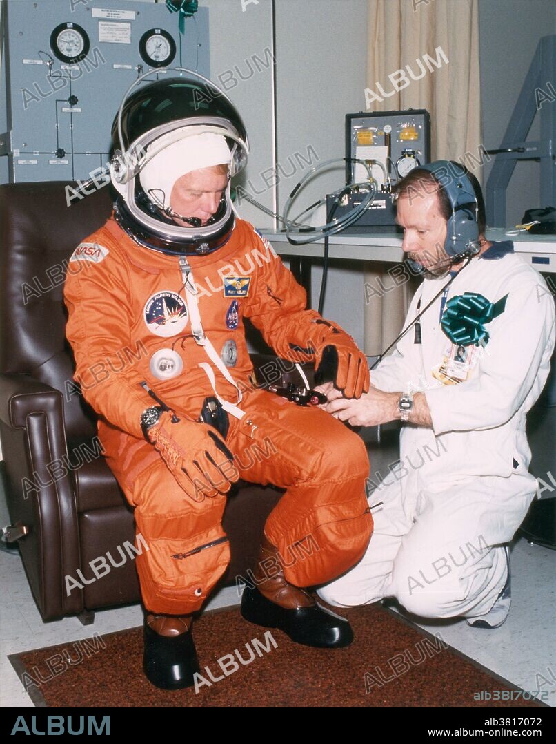 In preparation for Space Shuttle mission STS-26, Mission Specialist George "Pinky" Nelson suits up in his partially pressurized flight suit the morning of the launch of the orbiter Discovery. Kennedy Space Center, Florida. September 29, 1988.