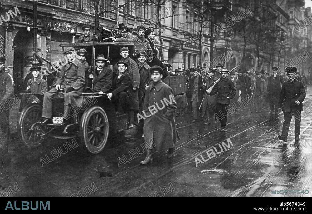 Berlin, 5.-15. Januar 1919. Januaraufstand / Januarkämpfe ("Spartakusaufstand"). (Die Absetzung des Polizeipräsidenten Eichhorn (USPD) am 4.1.1919, löst den Aufstand aus.). - Bewaffnete Spartakisten ziehen durch eine Straße Berlins.- Foto, Januar 1919. Berlin, Sammlung Archiv für Kunst und Geschichte.
