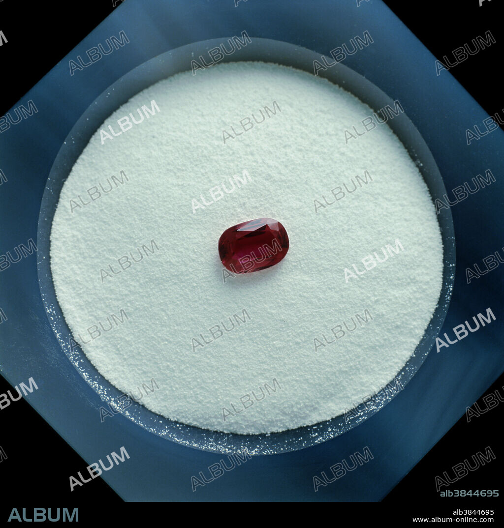 Aluminum oxide (known in its naturally occurring, crystalline form as corundum) and a cut ruby. Rubies are an impure form of aluminum oxide, which is used in grinding wheels and sand paper. Rubies are used in jewelry and lasers.