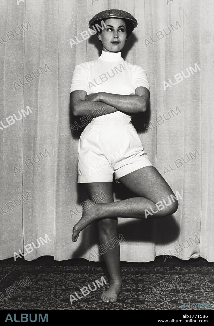 Portrait of Silvana Mangano in a funny pose. Portrait of Italian actress Silvana Mangano posing with a wicker basket on her head. 1950s.