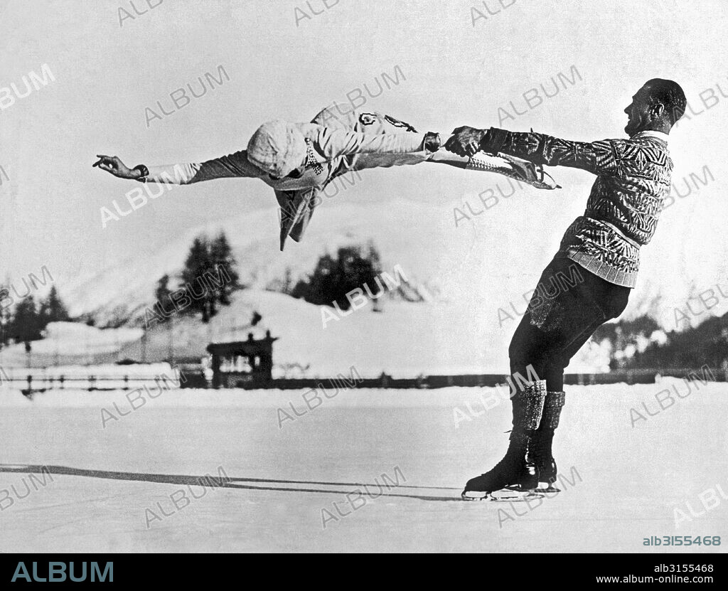 St. Moritz, Switzerland:  c. 1935. World-renowned New York figure skaters Freda Whitaker and Phil Taylor show some amazing acrobatics as they prepare for the next Winter Olympics.