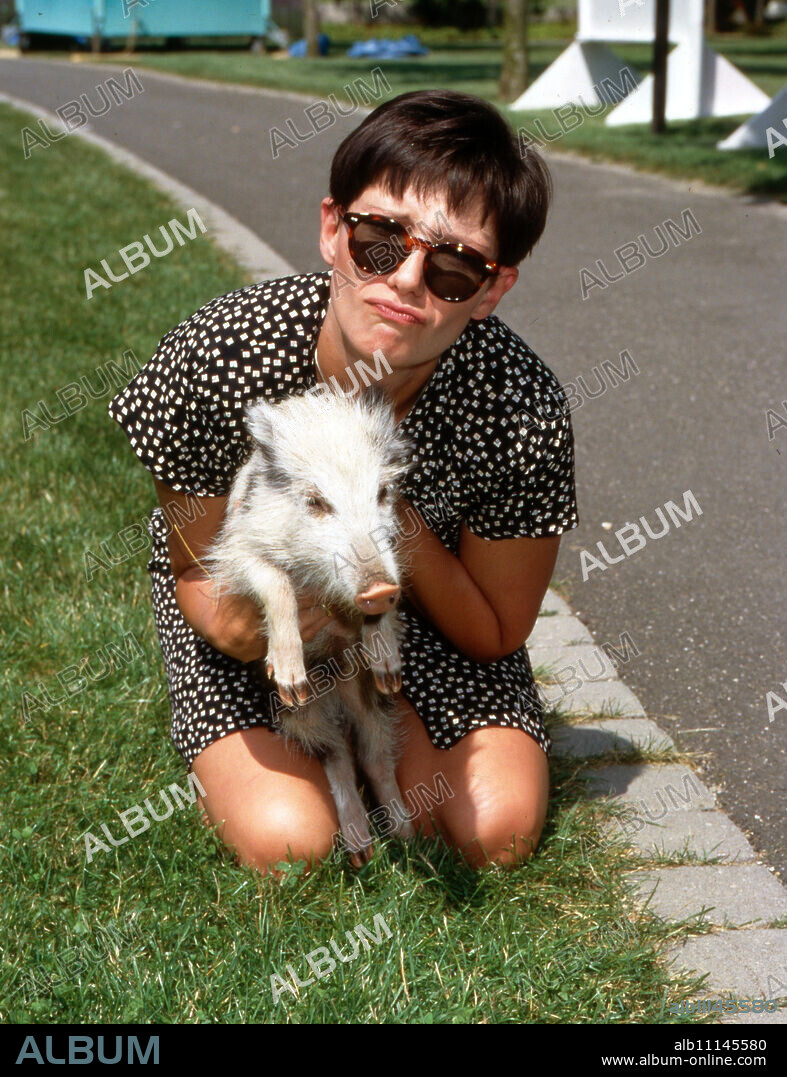 Raphaela Dell, new program announcer at ZDF in Mainz, romps around with Fritz the pig, Germany 1992. (original german headline: Raphaela Dell).