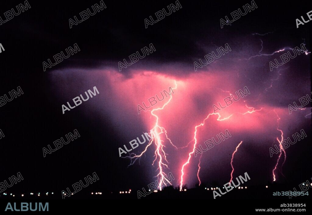 Lightning occurs when there is an electrical discharge within, or around, a thunderstorm. Cloud-to-ground lightning occurs when the electrical charge travels between a negatively charged cloud base and the positively charged ground. This is the most spectacular variation of lightning, forming brilliant, jagged bolts between the sky and the ground. A cloud-to-ground lightning stroke originating from higher based cloud structure. Lightning stroke penetrates a low level cloud before reaching earth.