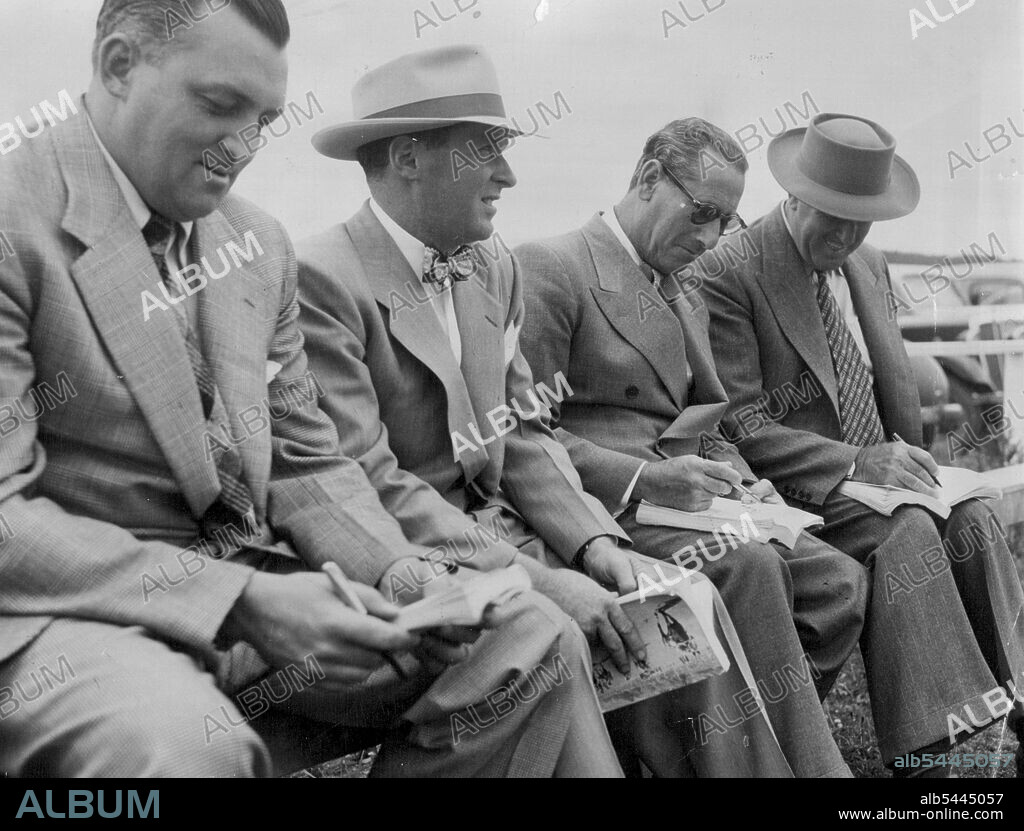 Australian buyers, (from left) trainer T.J. Smith bookmaker J. Mandel and C. Ewington consult ***** catalogues during a session of the N.Z. yearling. J. Rogan, T.J. Smith, J. Mandel & C. Ewington all Australians looking for a Caulfield Cup winner, from: left, J. Rogan, T.J. Smith, J. Mandel & C. Ewington. January 27, 1951. (Photo by Photo News Limited).