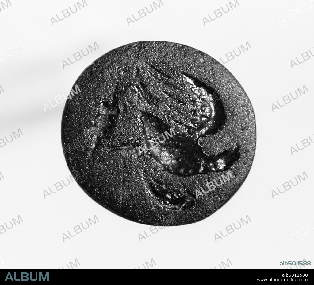 Eagle with spread wings, frontal body, head to the left, standing on lightning, gem, intaglio, ringstone, glass, Color: black, opaque, Shape: almost round, Processing: Maaskant-Kleibrink, M., Catalog of the engraved gems in the Royal Coin Cabinet, 1978, p.60, fig.2, type F1, 10 x 9 mm. Thickness 2 mm., 1st - 3rd century after Chr. 1-300, Netherlands, Limburg, unknown, unknown.