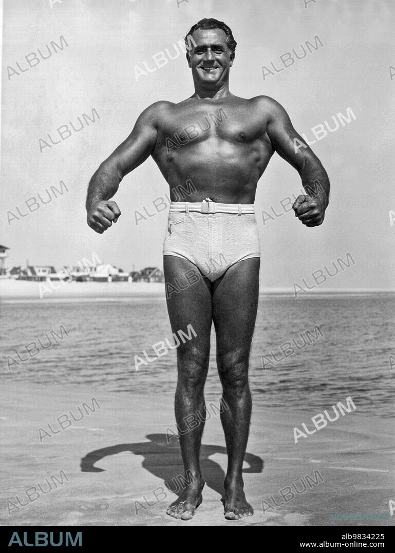 United States, June, 1939 World famous body builder Charles Atlas in one of his iconic comic book photo poses.