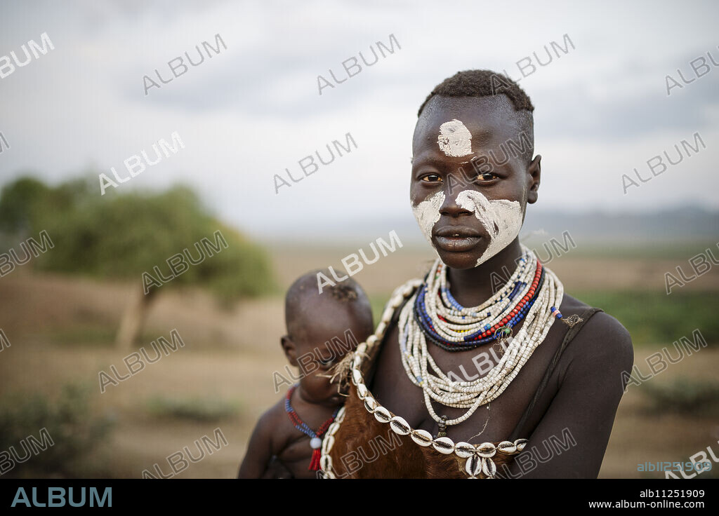 Portrait of Gabo with baby Nanega, Kara Tribe, Korcho Village, Omo Valley, Ethiopia, Africa.