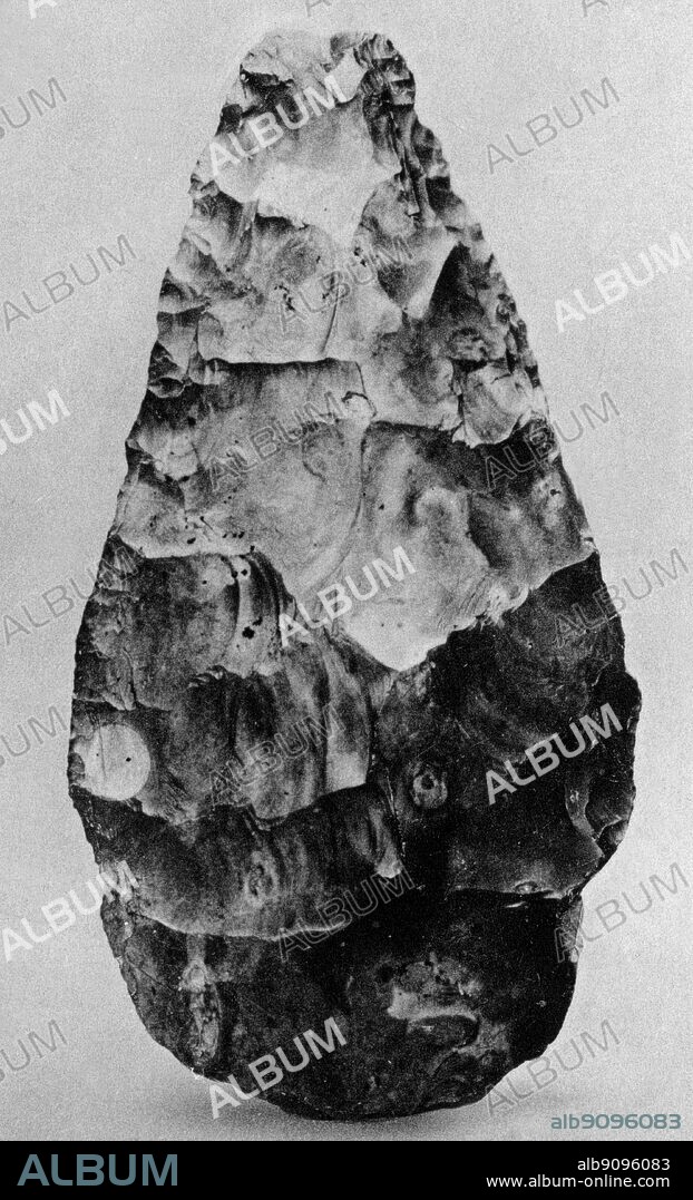Fossil Man. Lower palaeolithic flint hand axe, from gravel, 100 ft, terrace of Thames, Maidenhead. Circa 8 inches in height.