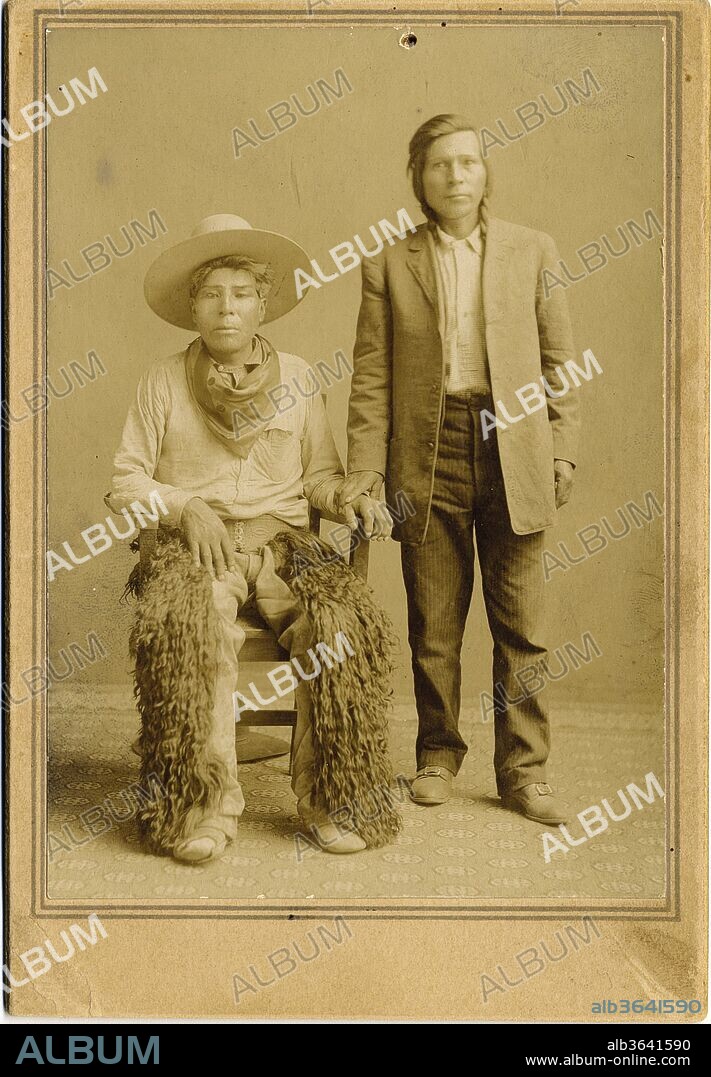 Native American Indian Cowboys Two Native American Indian Cowboys That Features A Nice Pair Of Buffalo Chaps. The Sitting Native American Wears The Chaps Along With A Hat, Bandana, And Plain Moccasins. The Standing Man Has Buckle-Top Boots And Long Hair., 1895.