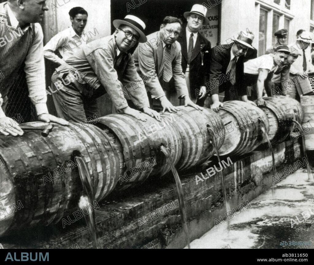 Federal agents enforcing the law against bootleg liquor in the 1930s. Prohibition in the United States was a nationwide Constitutional ban on the sale, production, importation, and transportation of alcoholic beverages that remained in place from 1920 to 1933. It was promoted by dry crusaders movement, led by rural Protestants and social Progressives in the Democratic and Republican parties, and was coordinated by the Anti-Saloon League. Prohibition was mandated under the Eighteenth Amendment to the U.S. Constitution. Enabling legislation, known as the Volstead Act, set down the rules for enforcing the ban and defined the types of alcoholic beverages that were prohibited. Private ownership and consumption of alcohol was not made illegal under federal law; however, in many areas local laws were more strict, with some states banning possession outright. Prohibition supporters, called drys, presented it as a victory for public morals and health. Anti-prohibitionists, known as wets, criticized the alcohol ban as an intrusion of mainly rural Protestant ideals on a central aspect of urban, immigrant, and Catholic life. Nationwide Prohibition ended with the ratification of the Twenty-first Amendment, which repealed the Eighteenth Amendment, on December 5, 1933. No location or photographer credited.