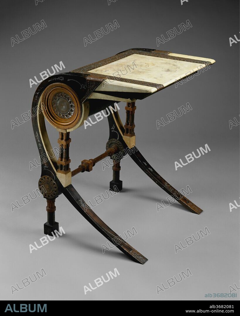 Desk. Artist: Carlo Bugatti (Italian, Milan 1855-1940 Molsheim). Dimensions: H. 29-1/2, W. 23-2/3, D. 22-1/2 in. (74.9 x 60.1 x 57.2 cm). Date: ca. 1902.
Strikingly original, Carlo Bugatti's furniture combines the picturesque asymmetry of Art Nouveau with the exoticism of Moorish and Japanese influences. Yet, there is nothing derivative in Bugatti's work; rather, it is pure fantasy, drawing inspiration from the Orientalist art movement of the late nineteenth century, a fact underscored by the name of his business in Milan: C. Bugatti & C., Fabbrica Mobili Artistici Fantasia. The writing surface of this desk is covered in vellum, held in place with punched copper strapping; the walnut legs are inlaid with pewter imitating calligraphic brush painting. The unusual profile of the desk suggests the jaws and teeth of an alligator. The model was used in one of Bugatti's few completed interiors-a theatrical bedroom designed about 1901 for the London residence of Lord Battersea.
